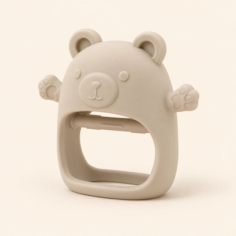 Oat bear teether with raised face, rounded ears, side paws and open-centre grip on warm beige.