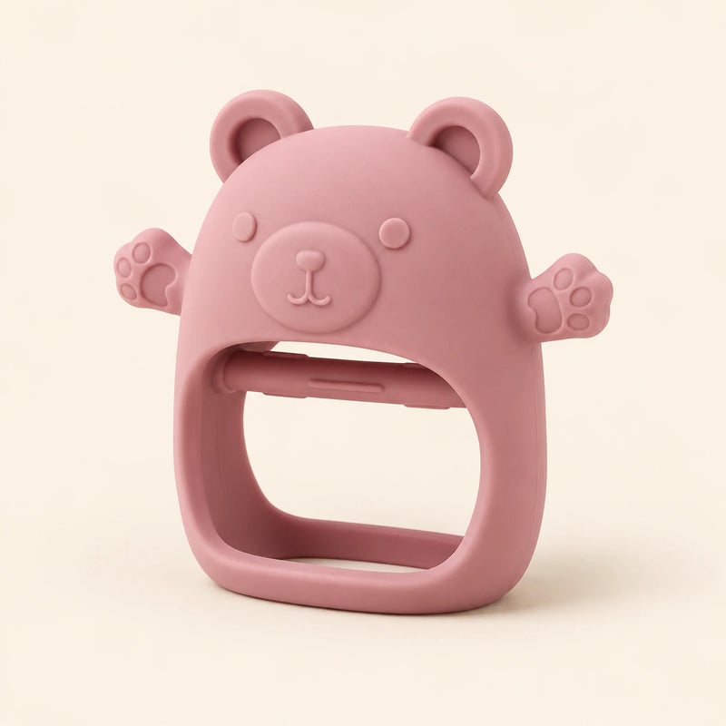 Dusty Rose bear teether with raised face, rounded ears, side paws and open-centre grip on warm beige.
