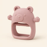 Light Brown bear teether with raised face, rounded ears, side paws and open-centre grip on warm beige.