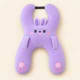 Lavender Bunny travel pillow with its original face, wraparound shape, front loops and upper strap on warm beige.