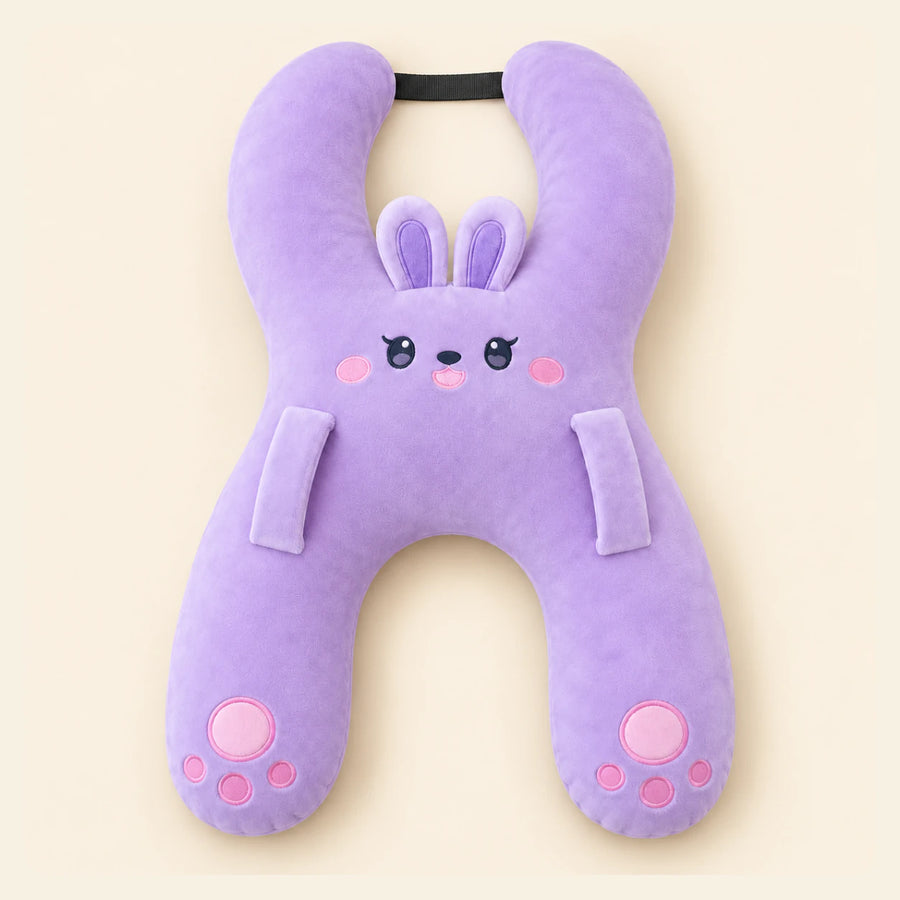 Lavender Bunny travel pillow with its original face, wraparound shape, front loops and upper strap on warm beige.