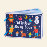 Original dark blue Winter Busy Book cover with winter characters and two blue binding rings on warm beige.