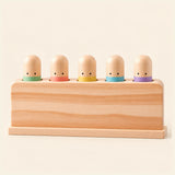Pastel Press Toy shown clearly on a smooth warm beige background.