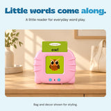 Pink talking flashcard reader showing the original owl card on a pale wood console beside a cream tote.