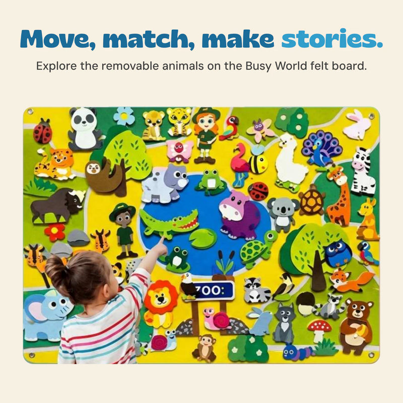 A child points to a crocodile on the colourful Busy World felt activity board.