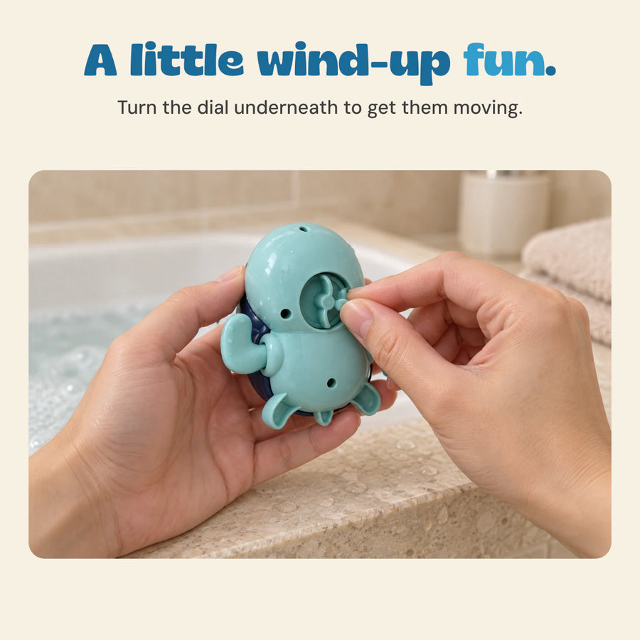 Hands turn the recessed wind-up dial underneath an aqua turtle bath toy.