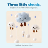 Close-up of the Blue Cloud Plush mobile's large smiling light blue cloud and two small white clouds, with brown dangling legs and white pom poms.