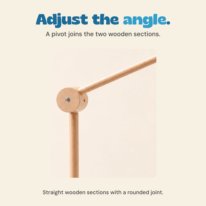 Close view of the round pivot joint connecting the straight upright pole and angled wooden mobile arm.